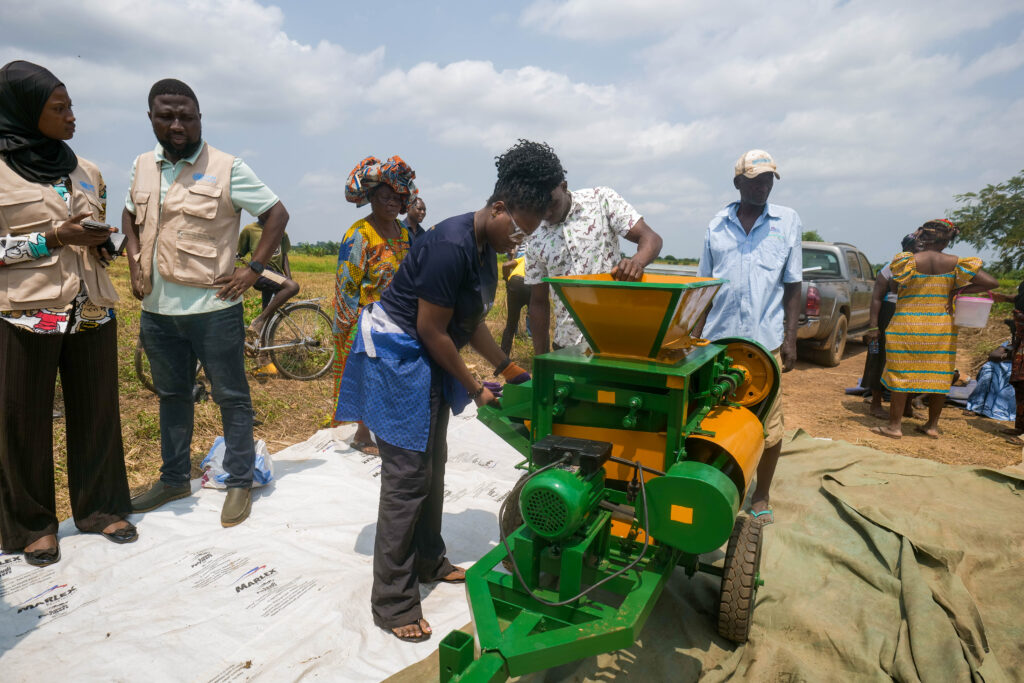 A photo of a group of people standing around a new machine which has been developed as part of the project. 